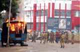 A police vehicle set ablaze by angry protesters