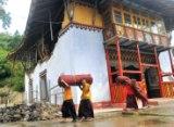 monks moving the contents of age old monastary damaged by the earthquake