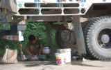 Preparing food under a truck on NH 39 during the general strike and road block