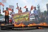 ABVP members protest and burn tyres at G.S Road protesting against the Bangladeshi nationals who were arrested with fake voters I card.