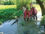 Raised bamboo structure as a passage over water. 