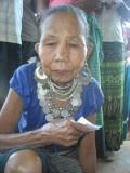 An old Reang woman rests from standing in queue