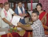 Himanta Biswa Sarma handing over an appointment letter to a TET qualified teacher