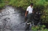 A villager stands next to an ONGC pipeline in Changpang village in Nagaland