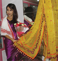 Assamese film actress Barasa Rani Bishaya trying out an exclusive Assamese traditional women’s garment at Guwahat