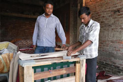 Kongkon Bora overseeing the manufacture of a sofa