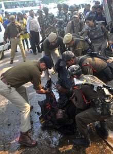 Security personnel trying to safely move Pranab Boro for medical care