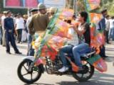 BJP supporters covered in party flags