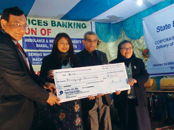 A Krishna Kumar MD SBI and Deborah Marak Minister of Social Welfare, Government of Meghalaya handing over a cheque