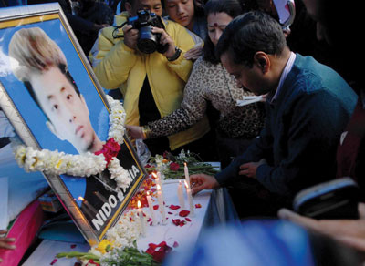 Arvind Kejriwal lighting a candle for Nido Tania