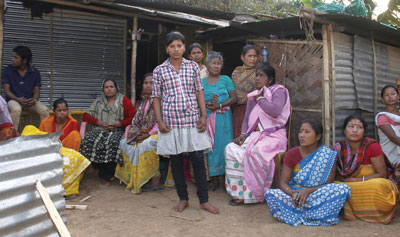 Family members and neighbors of Pranab Boro gathered at his home in Garchuk